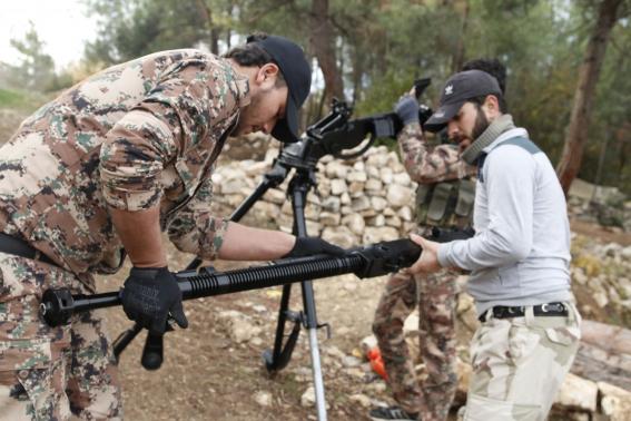 Rebel fighters prepare to fire a machine gun towards forces loyal to Syria's President Bashar al-Assad in the Jabal al-Akrad area in Syria's northwestern Latakia province November 25, 2014