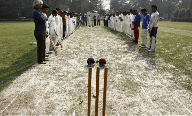 Members of two local cricket teams observe a moment of silence for Australian cricketer Phillip Hughes before their match in Kolkata. Phillip Hughes