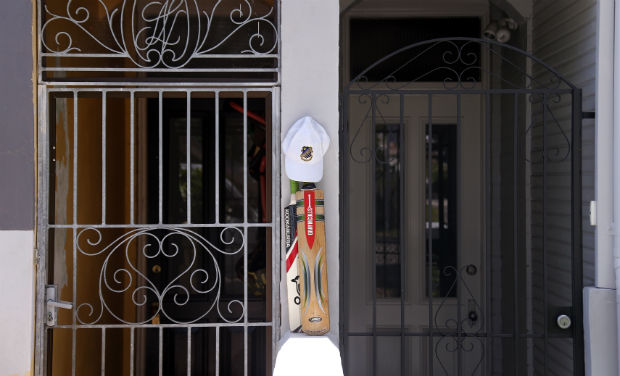A pair of cricket bats can be seen resting out the front of a home at Bondi Beach as a tribute to Phillip Hughes. Phillip Hughes