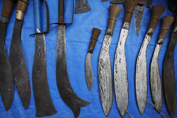 Sacrificial blades are displayed for sale near the enclosure for buffalos awaiting sacrifice on the eve of the sacrificial ceremony for the 