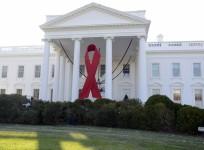 A giant red ribbon hangs from the North Portico of the White House to mark World AIDS Day, December 1, 2013,