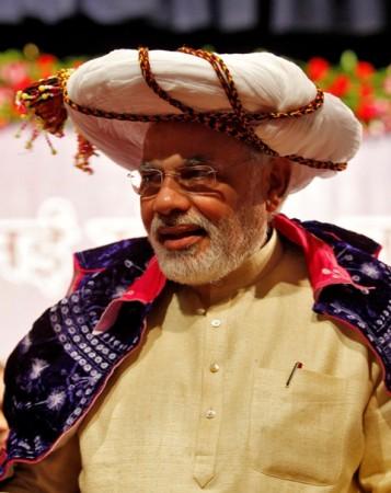 Modi wears a traditional headgear presented to him by a well-wisher during his 63rd birthday at Gandhinagar in Gujarat on 17 September 2013. Modi