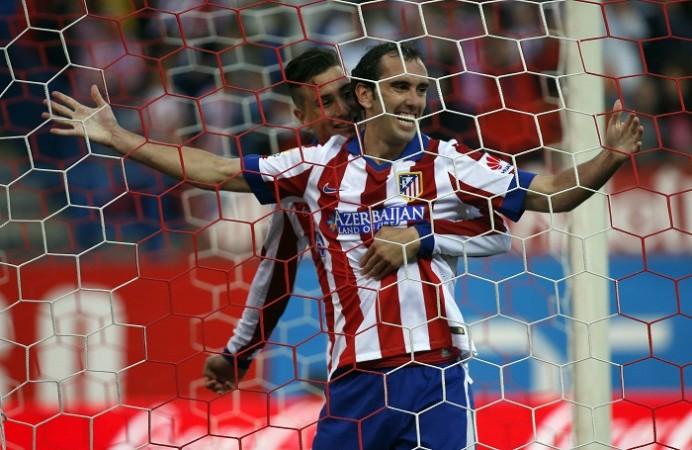 Atletico Madrid defender Diego Godin celebrates with teammate Raul Jimenez after scoring against Malaga in the Spanish league Diego Godin Raul Jimenez Atletico Madrid