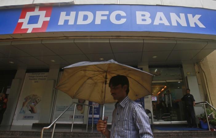 A man walks past a HDFC Bank branch HDFC Bank