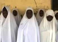 A group of Nigerian Muslim girls pray at an Islamic school.