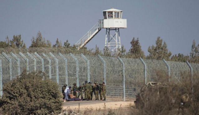 Israeli soldiers stand near the border with Syria in the occupied Golan Heights Israeli soldiers stand near the border with Syria in the occupied Golan Heights as they prepare to evacuate a wounded Syrian