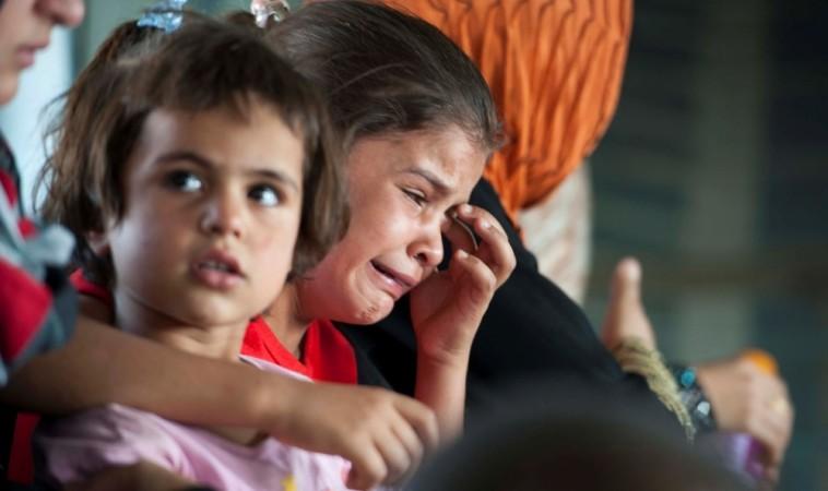 A child cries in a military helicopter after being evacuated by Iraqi forces from Amerli, north of Baghdad after the town was attacked by ISIS.