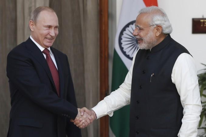 Russian President Vladimir Putin (L) shakes hands with India's Prime Minister Narendra Modi during a photo opportunity ahead of their meeting at Hyderabad House in New Delhi on 11 December 2014. modi putin