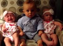 The video showing the comical moment a baby boy gets into a spin as he encounters twins for the first time.