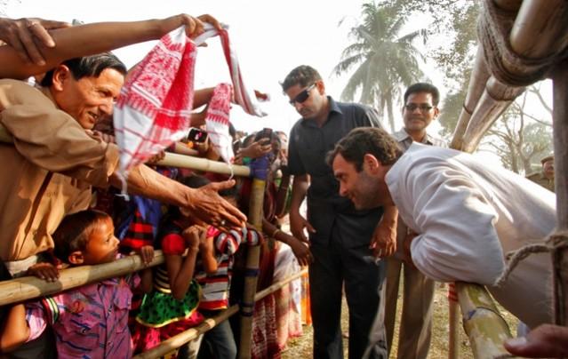 Rahul Gandhi speaks to children during a road show ahead of the 2014 general elections at Kathpara village in Assam. Rahul Randhi