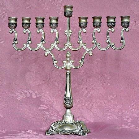 Hanukkah People who associate with this festival celebrate the holiday by lighting a special Hanukkah menorah or a candelabrum containing holders for 8 candles. One candle is lit with celebration of each day plus the ninth called the 'shammash' or