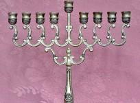 People who associate with this festival celebrate the holiday by lighting a special Hanukkah menorah or a candelabrum containing holders for 8 candles. One candle is lit with celebration of each day plus the ninth called the 'shammash' or