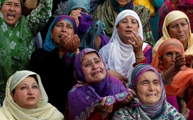 Kashmiri Muslim women react upon seeing a relic of Prophet Muhammad during Meraj-un-Nabi celebrations at the Hazratbal Shrine in Srinagar. Meraj-un-Nabi