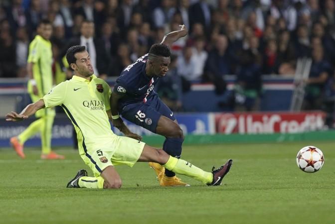 Barcelona midfielder Sergio Busquets challenges PSG striker Jean-Christophe Bahebeck for the ball during their Champions League game Sergio Busquets Barcelona Bahebec PSG