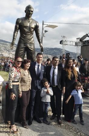 Cristiano Ronaldo and his family pose in front of his statue Cristiano Ronaldo Statue