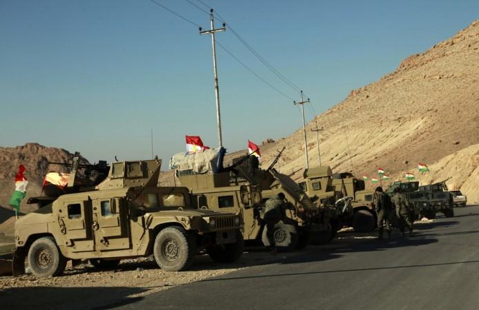 Military vehicles of Kurdish security forces are seen at Mount Sinjar, in the town of Sinjar, December 21, 2014. Iraqi Kurdish fighters flashed victory signs as they swept across the northern side of Sinjar mountain on Saturday, two days after breaking through to free hundreds of Yazidis trapped there for months by Islamic State fighters. Kurd Iraqis drive IS militants out of Sinjar