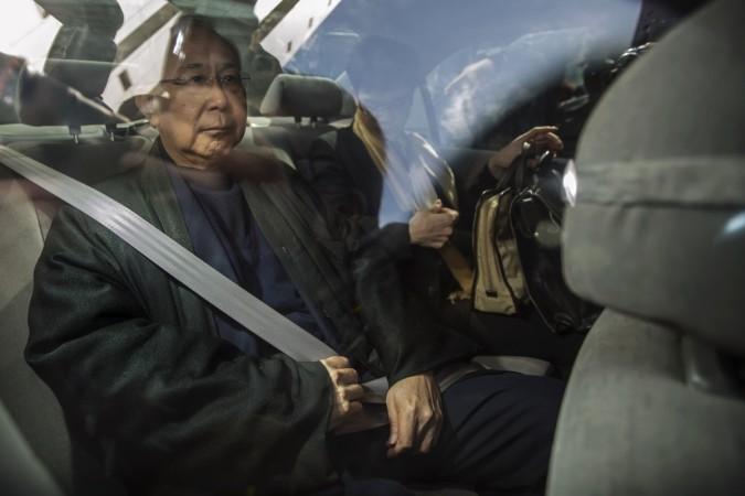 Hong Kong's former chief secretary Rafael Hui sits in a car as he leaves during a lunch break at the High Court in Hong Kong December 16, 2014. Hui is involved in one of the financial hub's largest corruption trials, charged with accepting Hong Kong's former chief secretary Rafael Hui