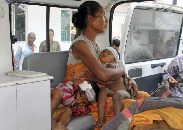 A woman belonging to the indigenous Bodo tribe, with her two children injured in an attack by tea garden workers, arrives at a hospital for treatment in Bongaigaon town in the northeastern Indian state of Assam December 24, 2014. Assam attack