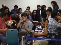 Family members of passengers onboard AirAsia flight QZ8501 react at a waiting area in Juanda International Airport, Surabaya December 28, 2014