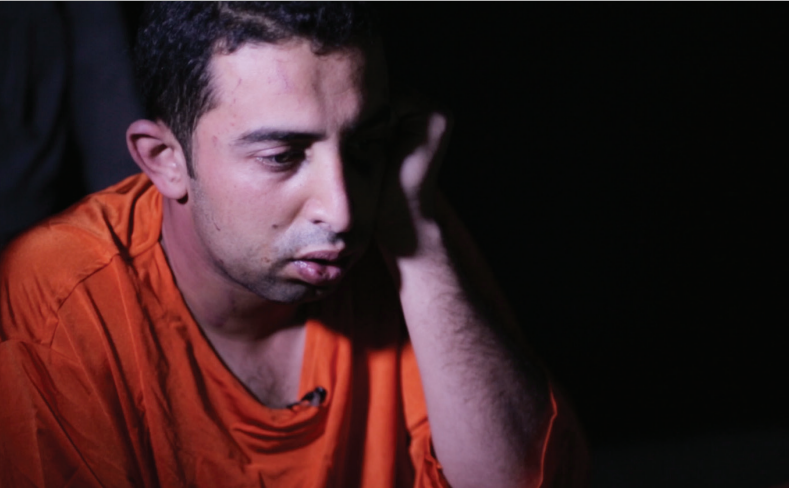 Muath al-Kasaesbeh is shown wearing an orange jumpsuit. Muath al-Kasaesbeh is shown wearing an orange jumpsuit.