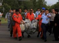 Members of the Search and Rescue Agency SARS carry debris recovered from the sea presumed from missing Indonesia AirAsia flight QZ 8501 at Pangkalan Bun, Central Kalimantan, December 30, 2014
