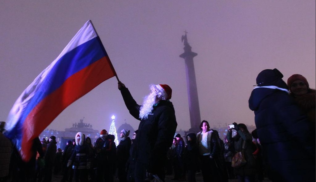 People celebrating New Year in front of the Winter Palace in St. Petersburg, Russia New year in Russia