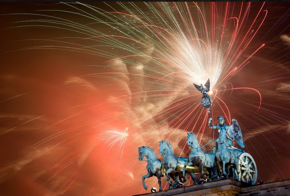 Fireworks light sky over Brandenburg Gate in New Year celebrations in Berlin, Germany New year in Germany