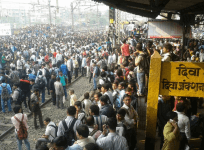 Commuters at Diva station,where angry protesters pelted stones and burned vehicles over delayed train.