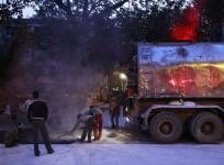 Labourers work during the early morning at the construction site of a road in Mumbai January 2, 2015.