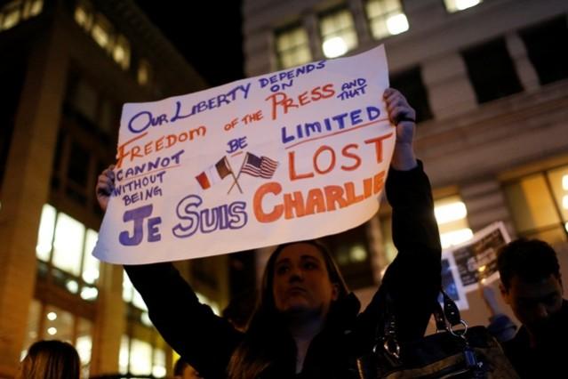 Tara Manning, an American who works for a French-American Company, holds a sign as people gather for a vigil outside the Consulate General of France to pay tribute to the victims of an attack on Charlie Hebdo in Paris, in San Francisco, California. Charlie Hebdo Paris Attack