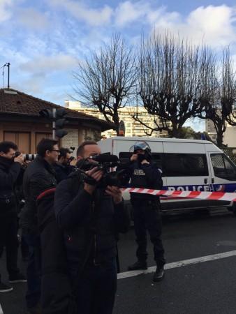 French police blocks the roads near a kosher grocery store as a terrorist militant holds several hostages in the store, in Porte de Vincennes, eastern Paris, on Jan. 9, 2015. French President Francois Hollande confirmed Friday night four hostages were kil
