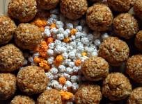 Multicolored sugar halwa surrounded by til-gul (sesame and jaggery) ladoos. These exchanged and eaten on Makara Sankranti in Maharashtra