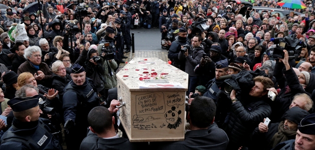 Pallbearers carry the coffin of late satirical French magazine Charlie Hebdo cartoonist Bernard Verlhac, known as Tignous, after a tribute at the Montreuil town hall, near Paris. Charlie Hebdo Paris Attack Funeral