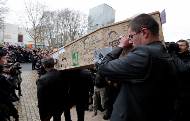 Pallbearers carry the coffin of late satirical French magazine Charlie Hebdo cartoonist Bernard Verlhac near Paris. Charlie Hebdo Paris Attack Funeral