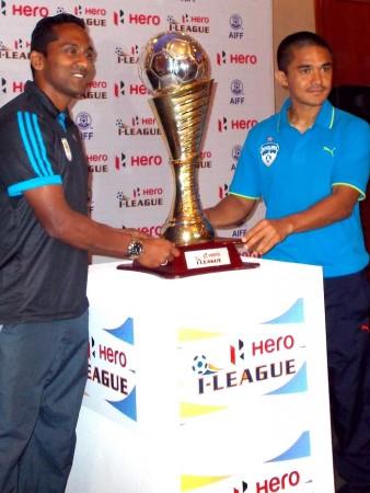 Dempo captain Clifford Miranda and Bengaluru FC captain Sunil Chhettri pose with the ISL trophy I-League