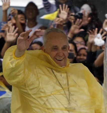 Pope Francis smiles as he waves to residents during a motorcade in Tacloban city, after holding a mass near the airport, January 17, 2015. The Sunday Mass held in a park in Manila is expected to draw a crowd of 6 million people. Pope Francis holds mass in Philippines