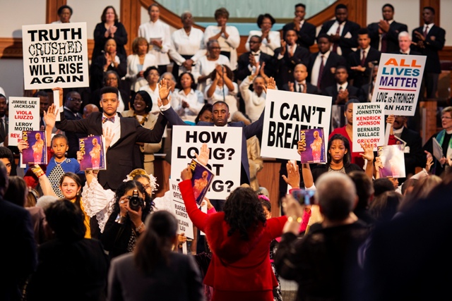 High school and college students hold civil rights signs during The King Center's 47th Annual Martin Luther King Jr. Commemorative Service in Atlanta. Martin Luther King Jr. Day