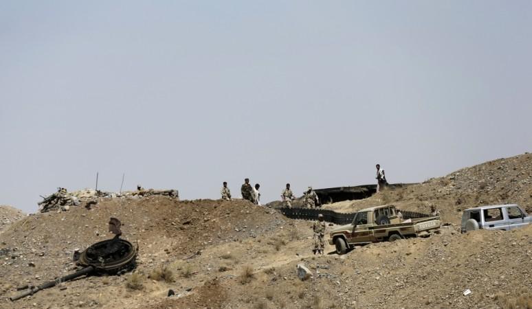 Houthi fighters walk at a presidential guards barrack on a mountain overlooking the presidential palace in Sanaa January 20, 2015. Houthi fighters storm presidential palace
