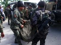 Philippine National Police (PNP) carry a body bag, containing a member of the Special Action Force, to a van in Mamasapano town, Maguindanao province, January 26, 2015. At least 30 people were killed in heavy fighting between police and Muslim rebels in t