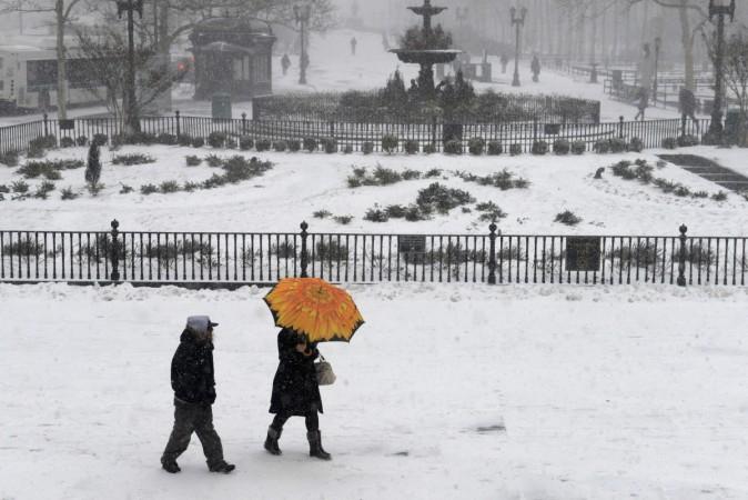 People walk in the Borough Hall section of downtown Brooklyn in New York City in falling snow, January 26, 2015. Blizzard in New York