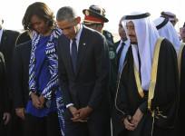 U.S. President Barack Obama and first lady Michelle Obama stand with Saudi Arabia's King Salman (R) after arriving at King Khalid International Airport in Riyadh, January 27, 2015.