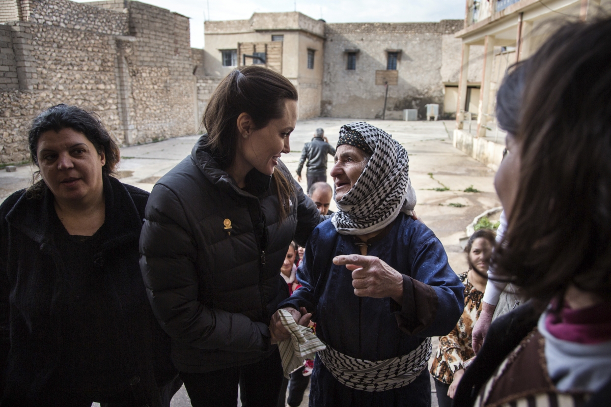 United Nations High Commissioner for Refugees (UNHCR) Special Envoy Angelina Jolie (2nd L) meets displaced Iraqis who are members of the minority Christian community, living in an abandoned school in Al Qosh, northern Iraq January 26, 2015. Angelina Jolie