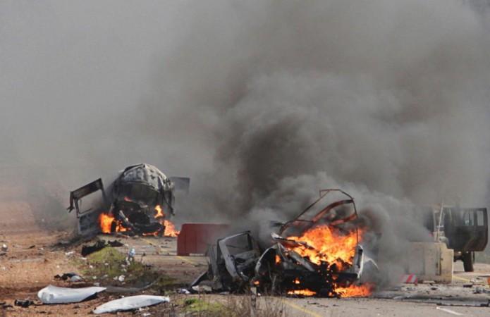Vehicles burn Wednesday near the village of Ghajar on Israel's border with Lebanon.