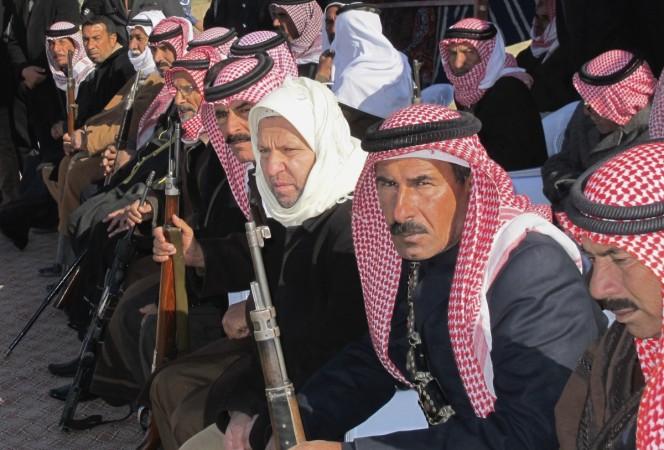 Sunni volunteers carry weapons during a parade as they prepare to fight against militants of the Islamic State, in the town of Amriyat al-Falluja in Anbar province, January 8, 2015.