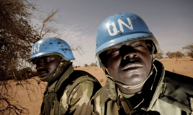 UNAMID peacekeepers patrol on the outskirts of a town in West Darfur