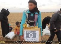 A Syria refugee carries a cardboard box containing food parcel distributed by ISIS. The images shows that the Islamic State has pasted its logo over the WFP label.
