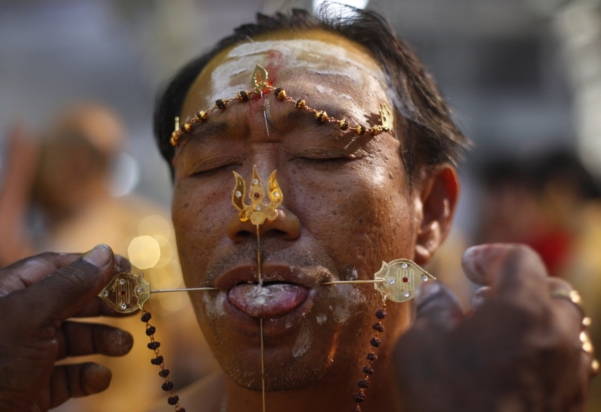 An ethnic Chinese devotee has his tongue pierced during Thaipusam festival in Singapore. Thaipusam 2015