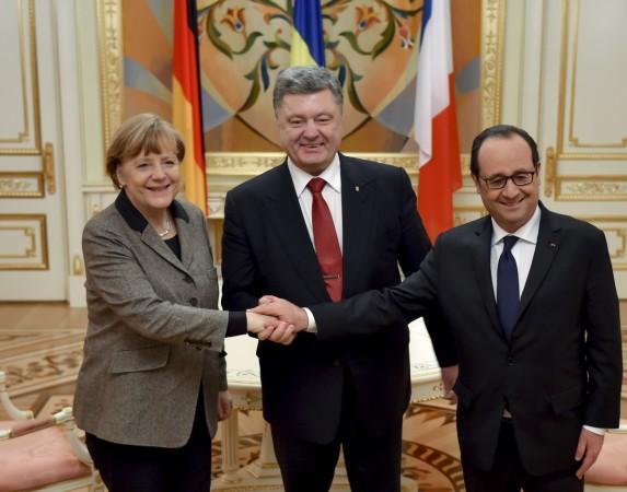 Ukraine's President Petro Poroshenko (C) shakes hands with German Chancellor Angela Merkel and French President Francois Hollande during their meeting in Kiev, February 5, 2015. Ukraine's President Petro Poroshenko (C) shakes hands with German Chancellor Angela Merkel and French President Francois Hollande during their meeting in Kiev, February 5, 2015.