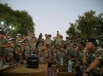 Jordan's King Abdullah (R) listens to members of the Jordanian army during his visit to a northern borders guards
