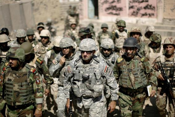 Major-General Mark Hertling (C), the commander of the U.S. forces in northern Iraq, walks during a battlefield circulation patrol on the streets in Mosul in June 19, 2008 file photo.